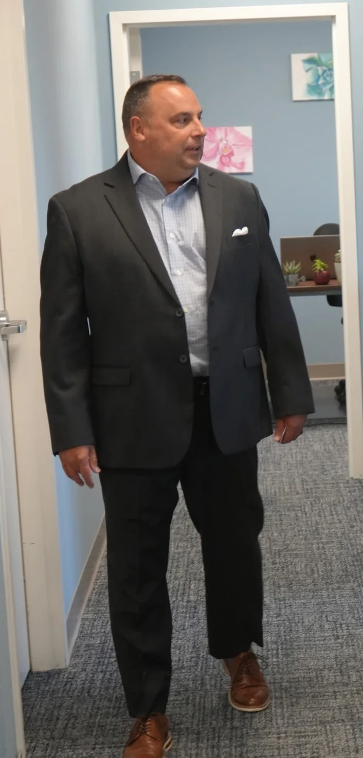 Mark Slider walking through an education facility